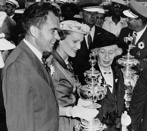 Pat Nixon holding a trophy among a crowd