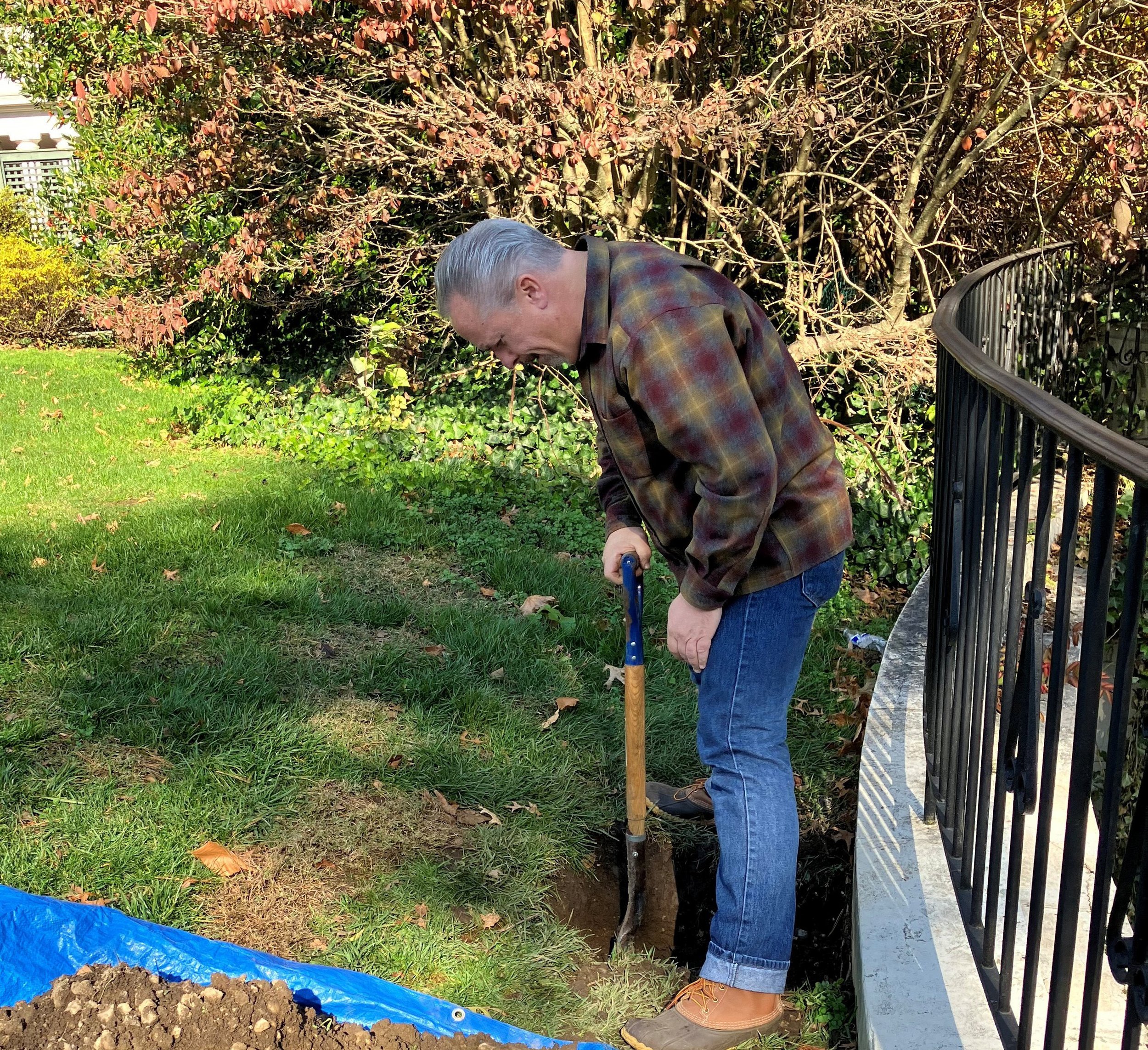Architectural conservator Kurt Hirschberg examining soil content of lawn at top of Overlook